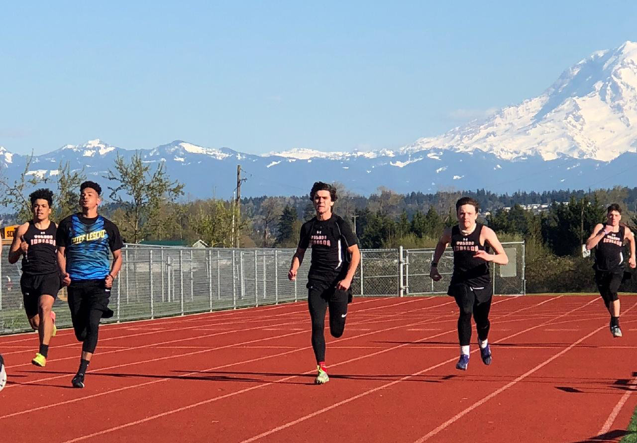 From left, Toledo's Jacob Marley, a Chief Leschi runner, TOledo's Carlo Arceo-Hansen, Toledo's Trey Rego and Toledo's Zack Smith run in the boys 200-meter dash.